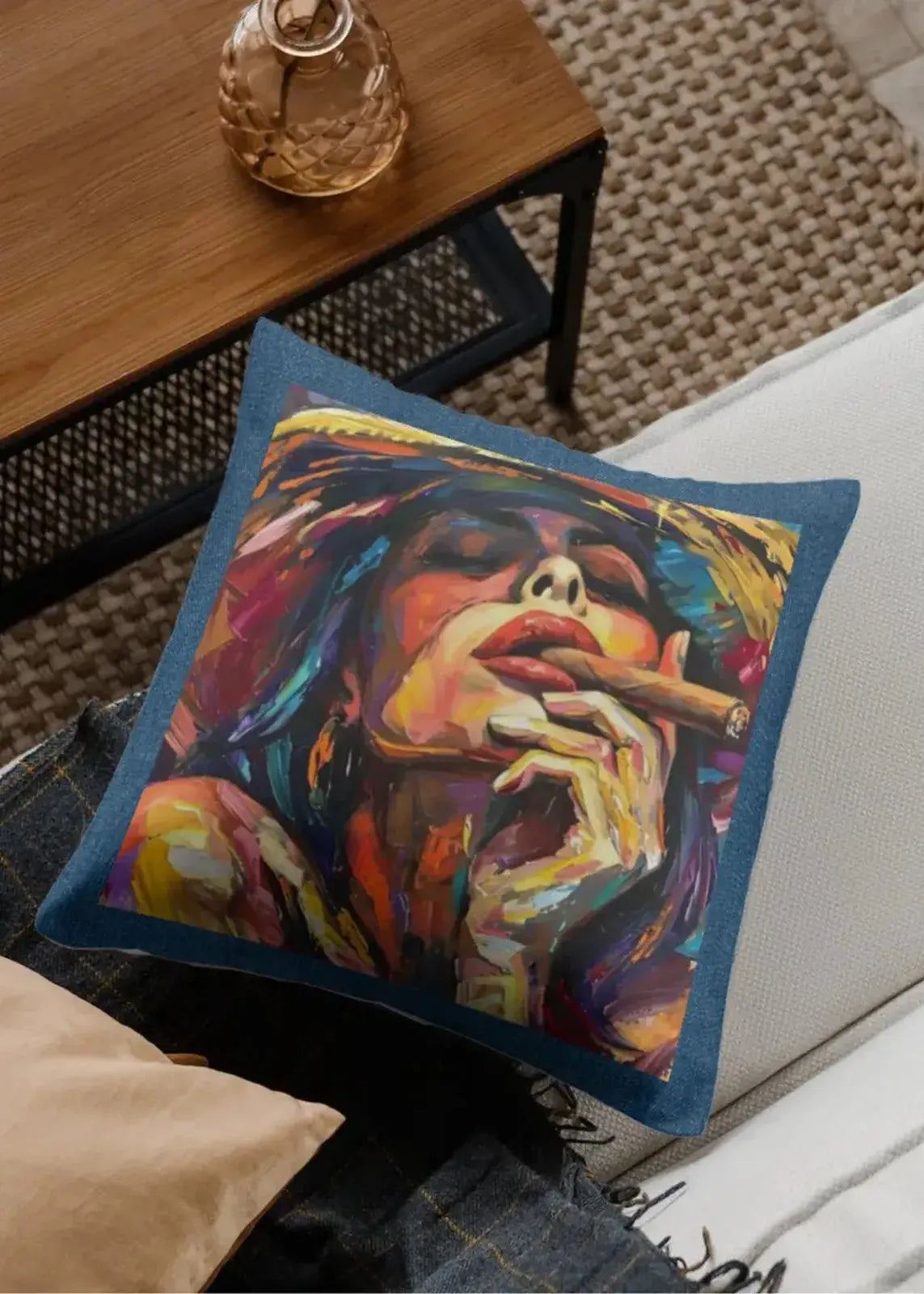 Colorful pillow with a artistic depiction of a person smoking on a couch.