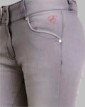 Gray riding pants with a brand logo on a light gray background