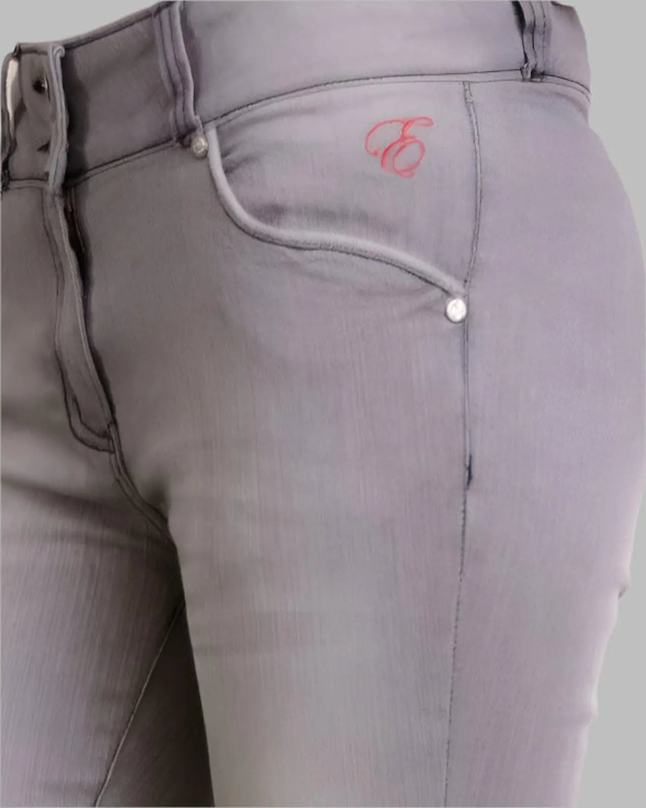 Gray riding pants with a brand logo on a light gray background