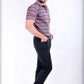 Man wearing a striped polo shirt and dark pants on a white background