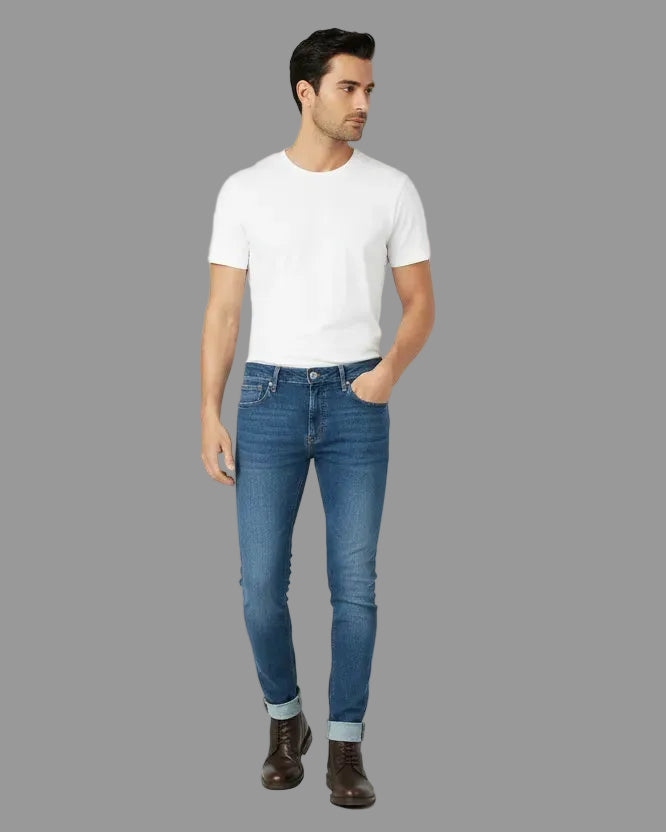Man wearing a white t-shirt and blue jeans on a white background