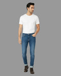 Man wearing a white t-shirt and blue jeans on a white background