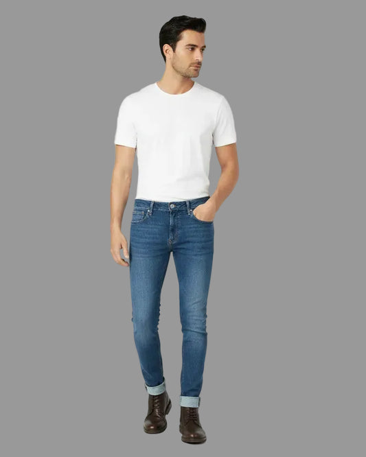 Man wearing a white t-shirt and blue jeans on a white background