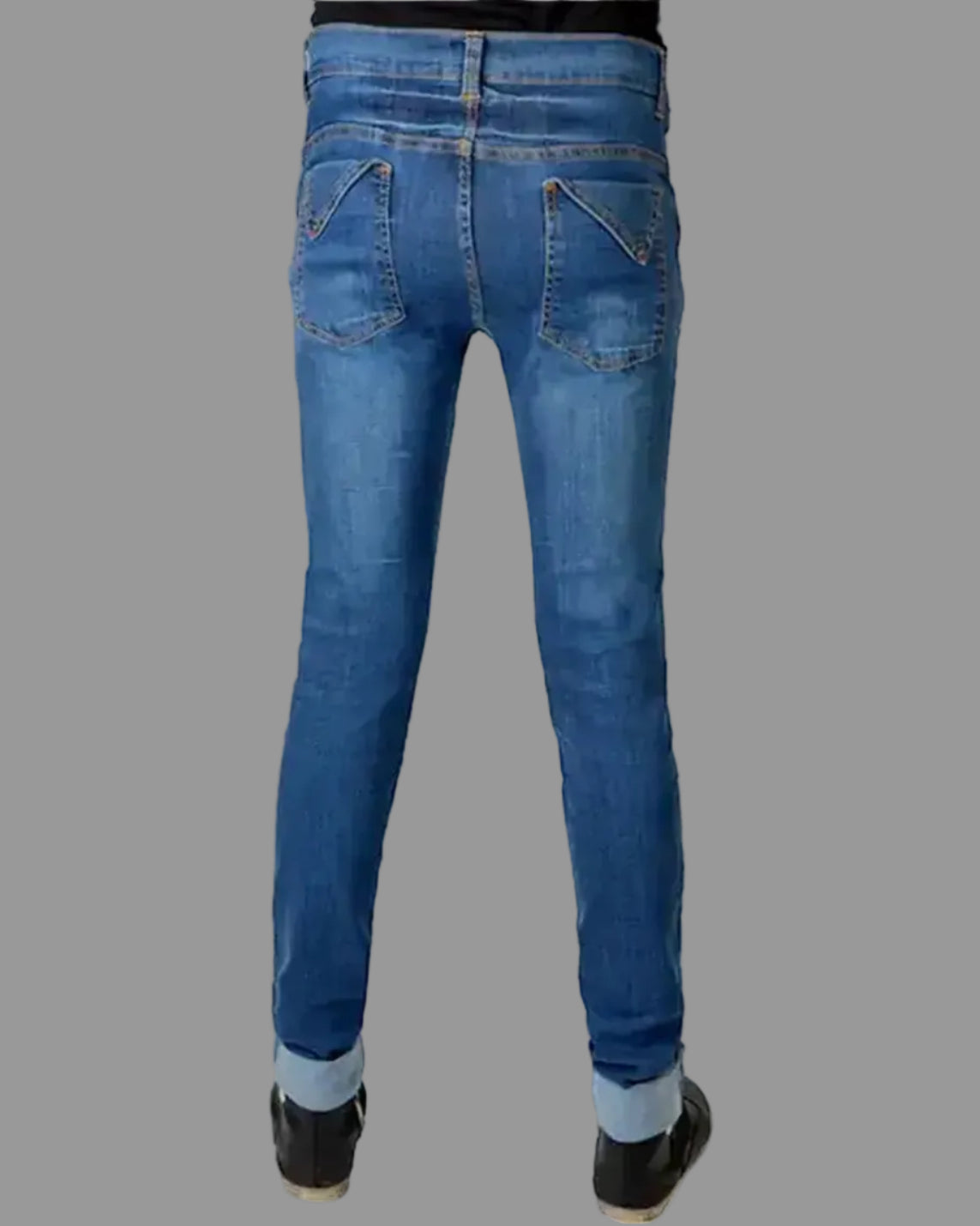 Blue jeans worn by a person on a white background