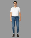 Man wearing a white t-shirt and blue jeans on a white background