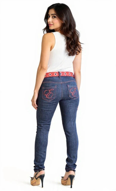 Woman wearing blue jeans with a red belt and white top on a white background