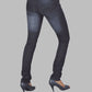 Dark blue jeans worn by a person on a gray background