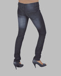 Dark blue jeans worn by a person on a gray background