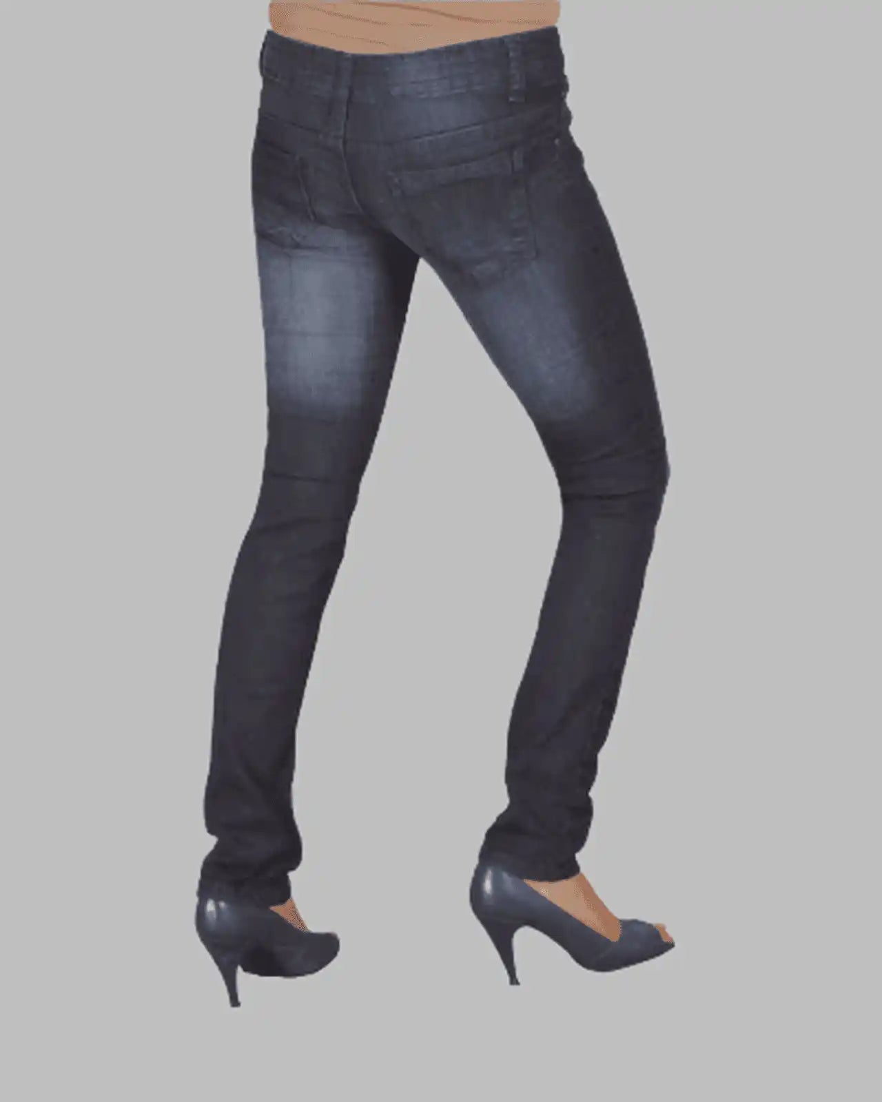 Dark blue jeans worn by a person on a gray background