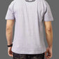 Person wearing a gray t-shirt with a logo on the back against a gray background