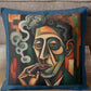 Decorative pillow with a stylized face design on a couch