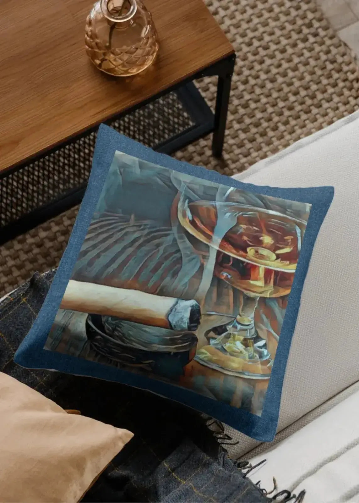 Decorative pillow with a glass of whiskey and a cigar on a couch.