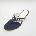 Denim sandal with pearl embellishments on a white background
