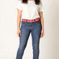 Woman wearing blue jeans with a red belt on a white background