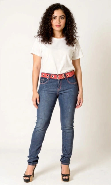 Woman wearing blue jeans with a red belt on a white background