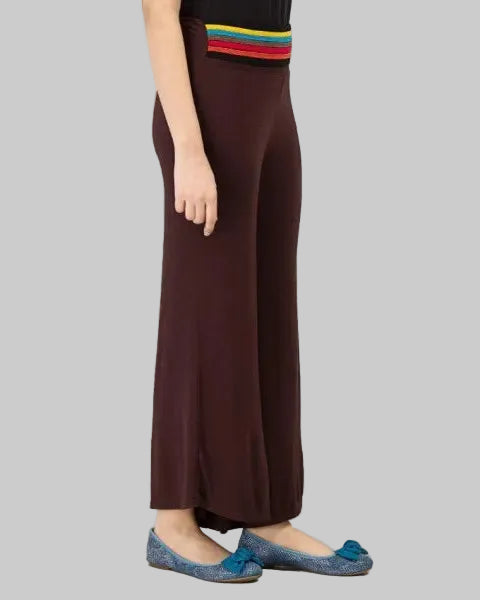 Brown wide-leg pants worn by a person on a gray background