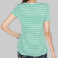 Person wearing a green striped shirt and dark jeans on a gray background