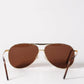 Brown sunglasses with gold frames on a white background