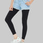 Person wearing black leggings, light blue denim shorts, and white sneakers on a white background
