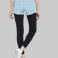 Person wearing light blue denim shorts and black leggings on a white background