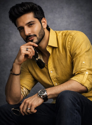 Man in a yellow shirt with a dark background
