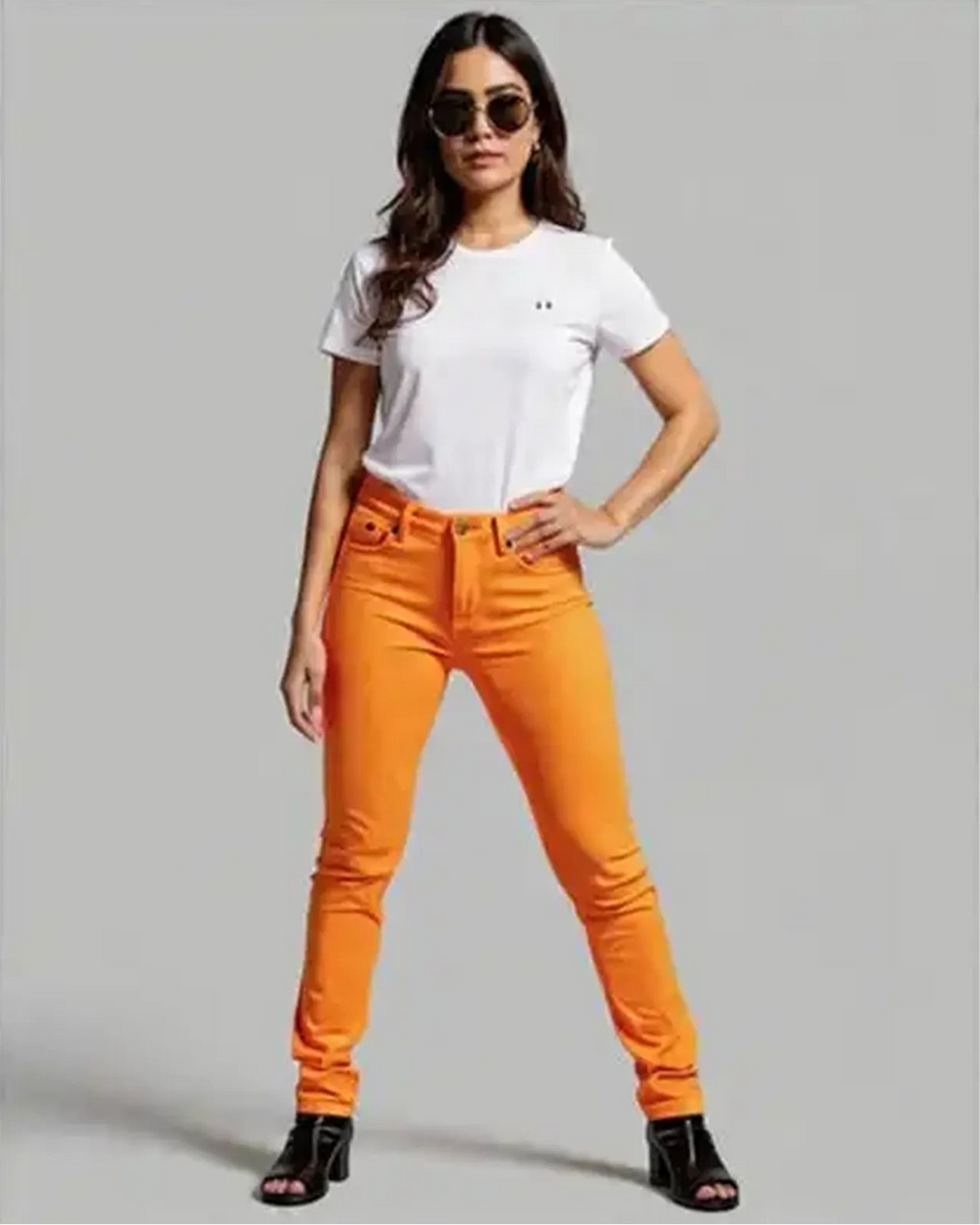Person wearing bright orange pants on a plain background