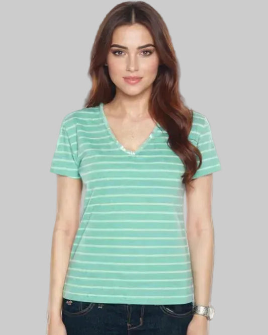 Woman wearing a green striped t-shirt against a gray background